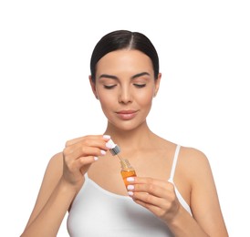 Young woman with bottle of essential oil on white background