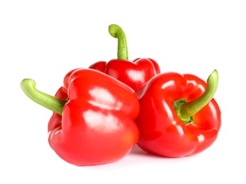 Tasty ripe red bell peppers on white background