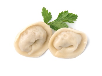 Photo of Fresh boiled dumplings and parsley leaf on white background, top view