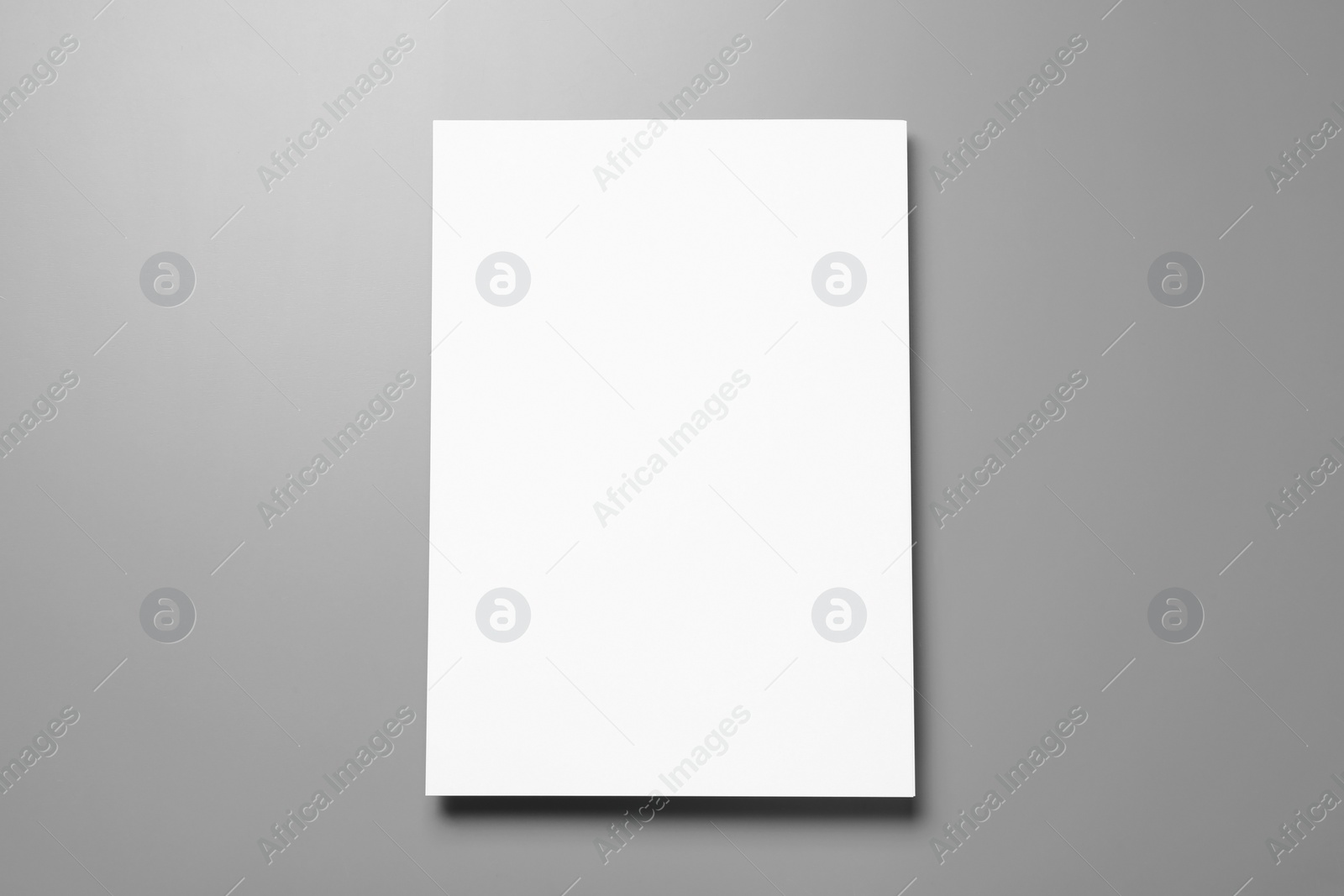 Photo of Blank paper sheets for brochure on grey background, top view. Mock up