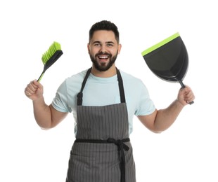 Young man with brush and dustpan on white background