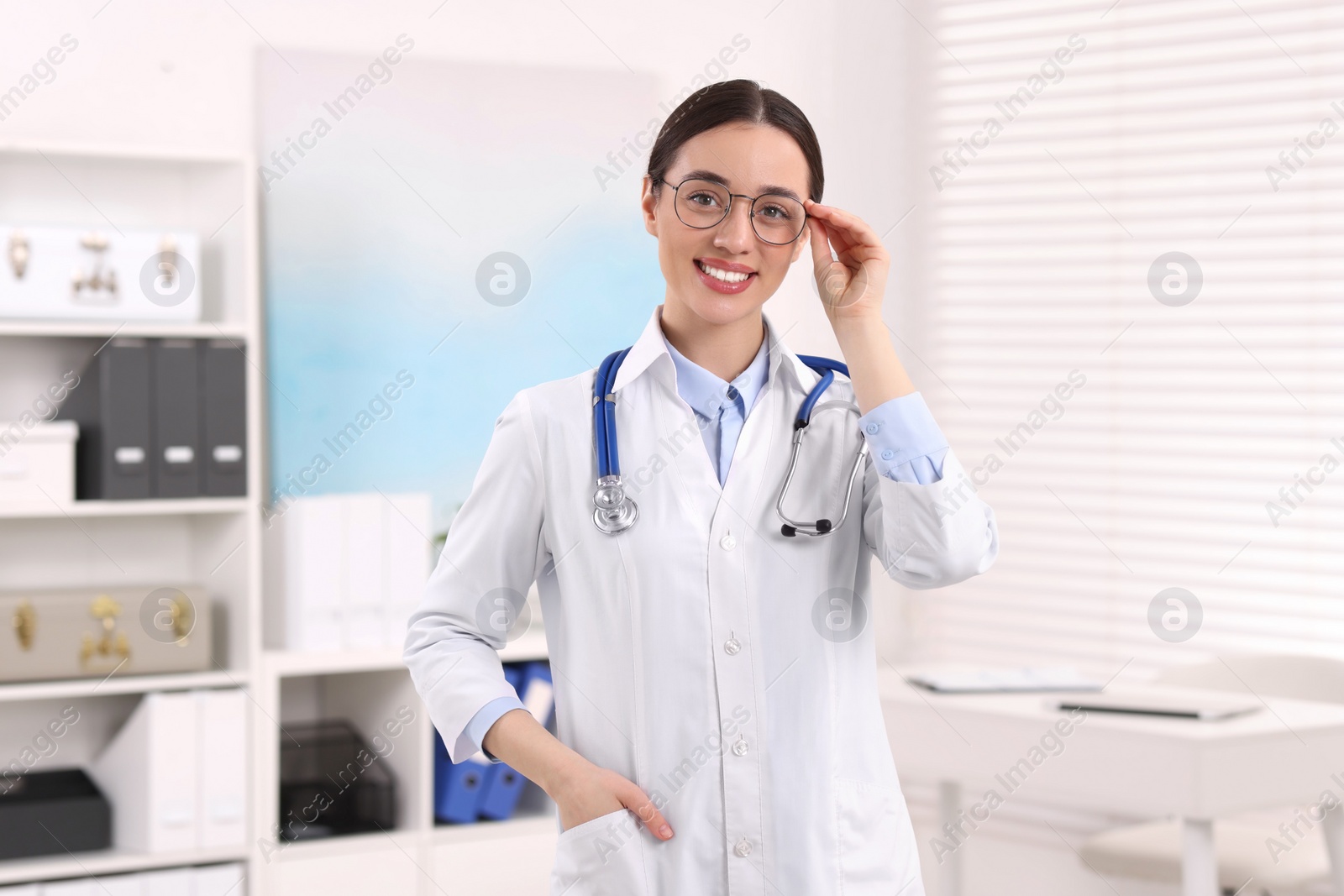 Photo of Medical consultant with glasses and stethoscope in clinic