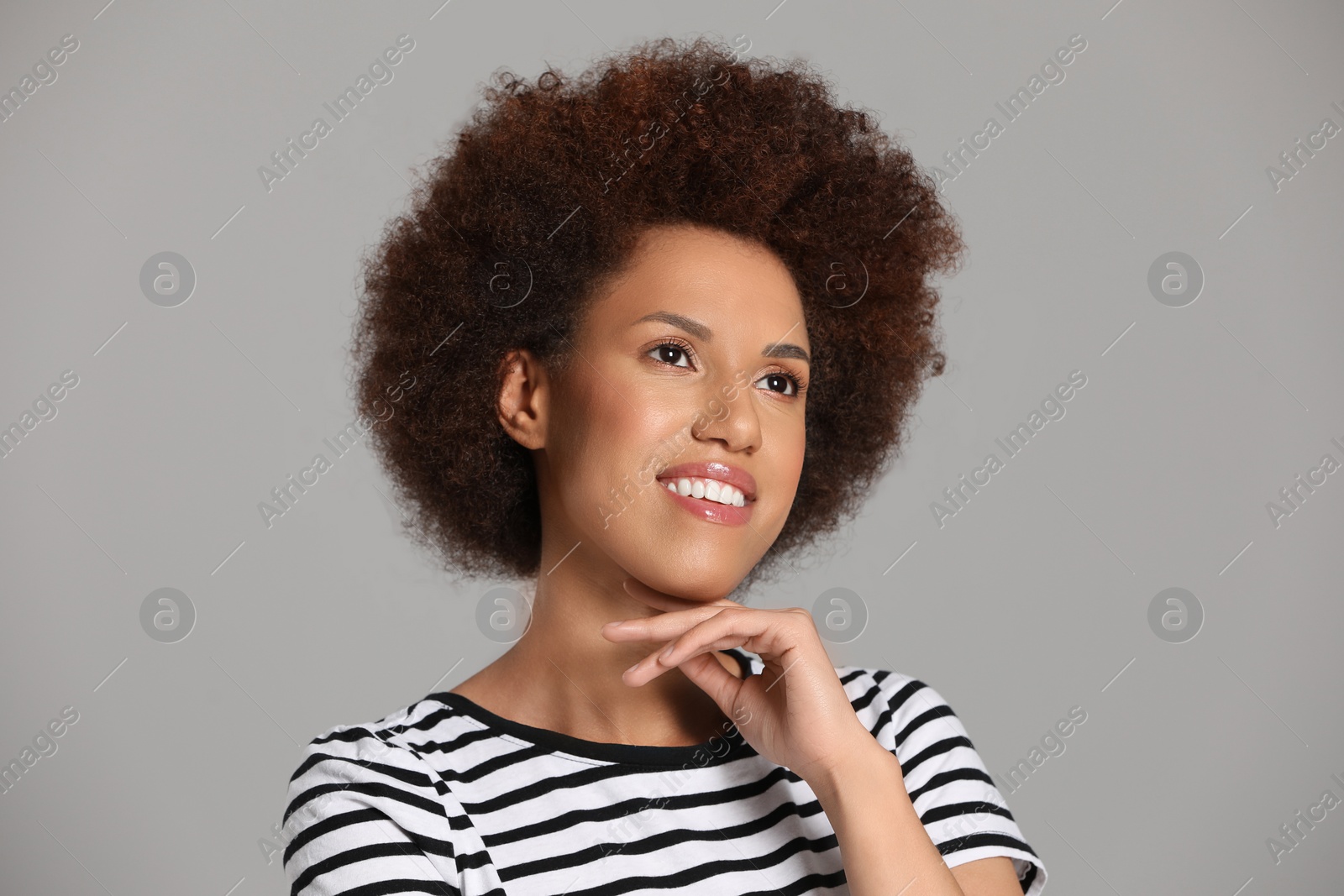 Photo of Portrait of beautiful young woman with glamorous makeup on grey background