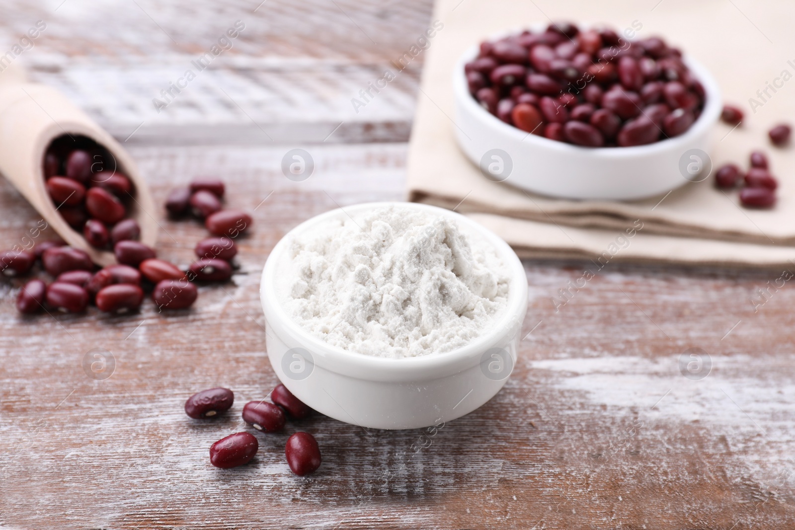 Photo of Kidney bean flour and seeds on wooden table