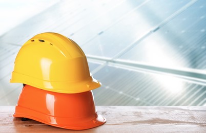 Image of Hard hats on wooden surface at construction site. Space for text 