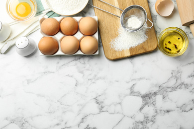 Photo of Flat lay composition with chicken eggs on white marble table. Space for text