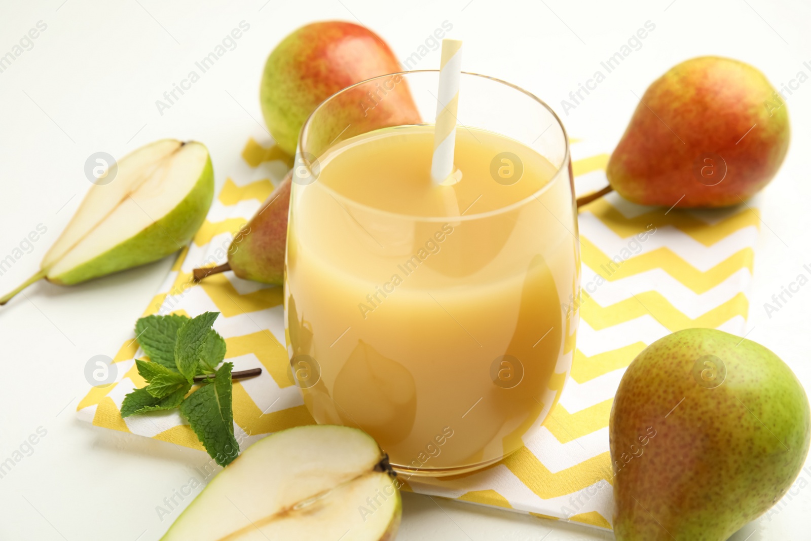 Photo of Tasty pear juice and fruits on white table, closeup