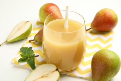 Tasty pear juice and fruits on white table, closeup