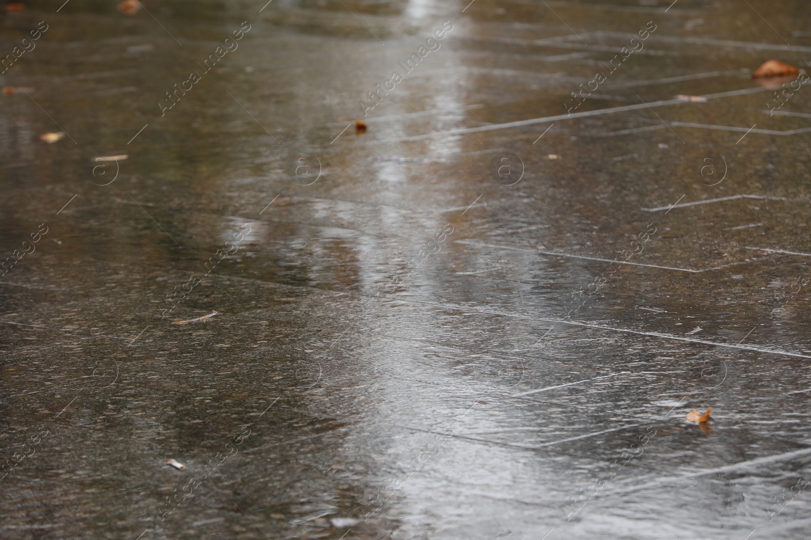 Photo of Wet pavement on city street after rain