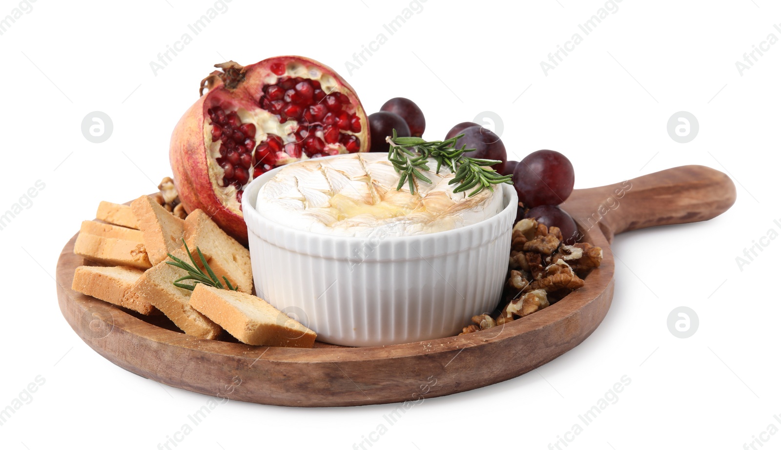 Photo of Board with tasty baked camembert, croutons, grapes, walnuts and pomegranate isolated on white