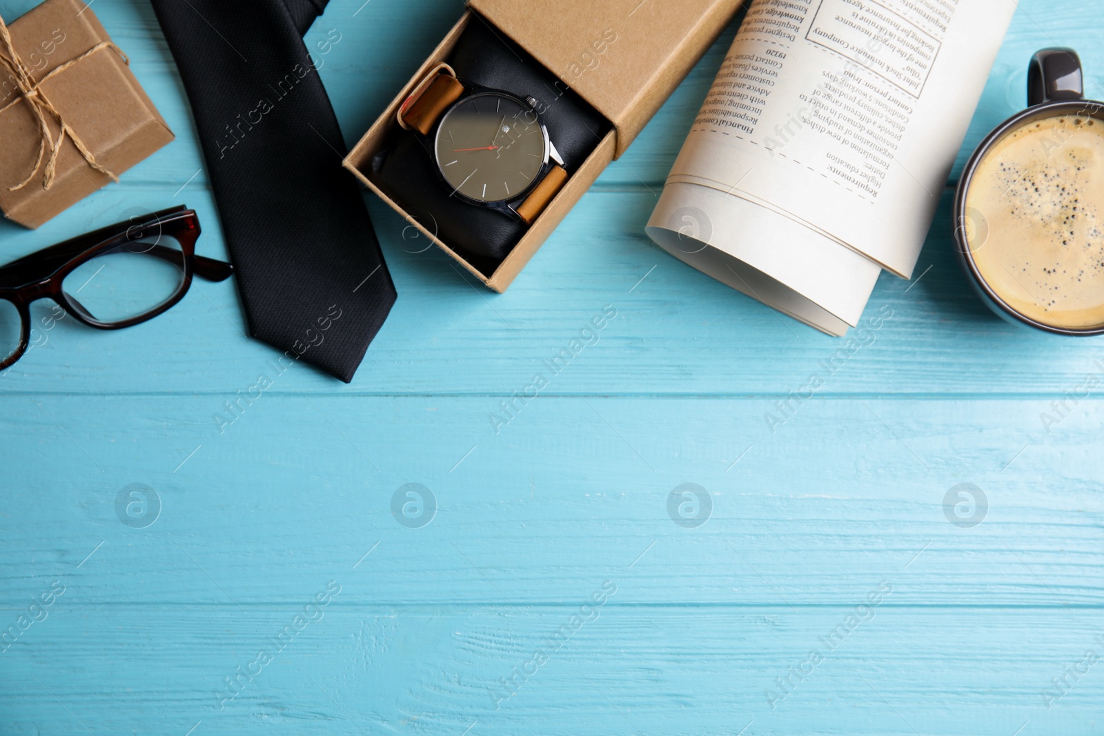 Photo of Flat lay composition with male accessories on light blue wooden table, space for text. Happy Father's Day