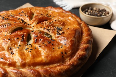 Photo of Tasty homemade pie with filling on grey table, closeup