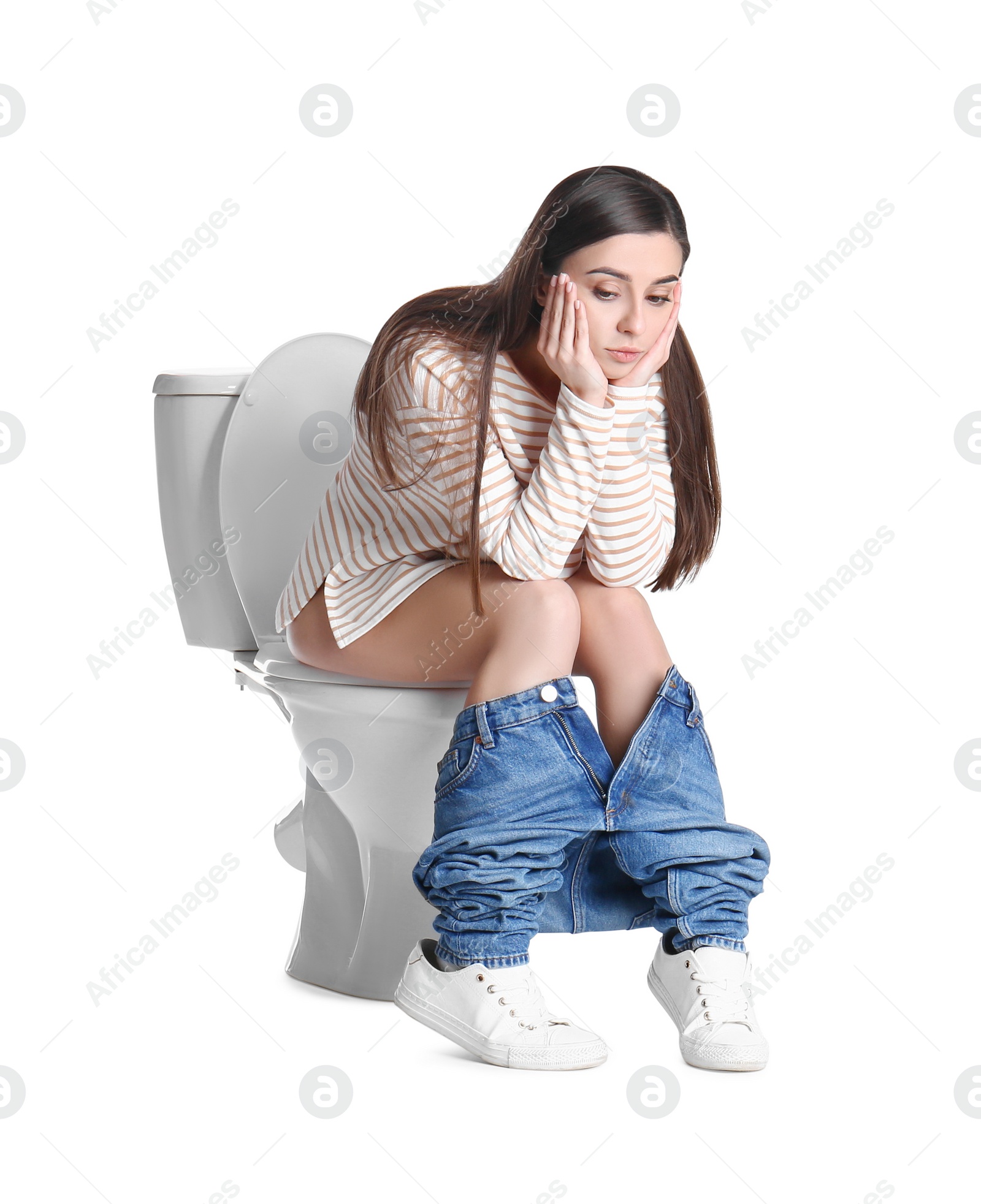 Photo of Upset woman sitting on toilet bowl, white background