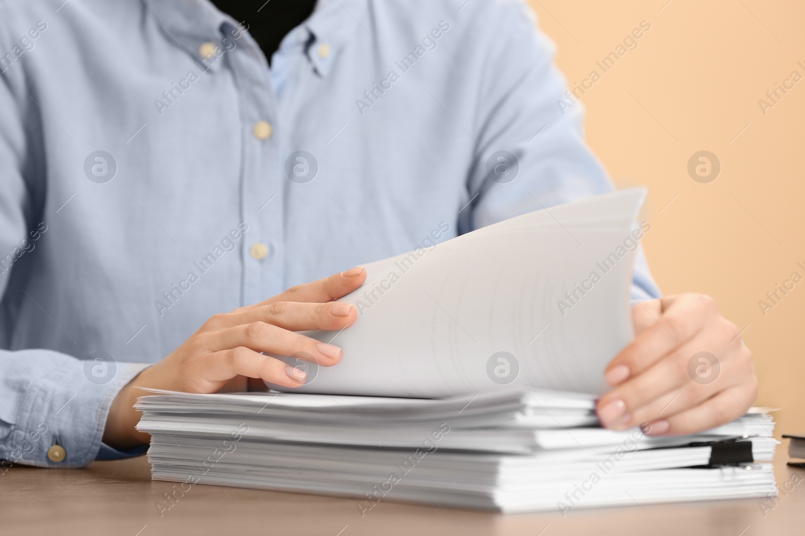 Photo of Woman working with documents at table in office, closeup