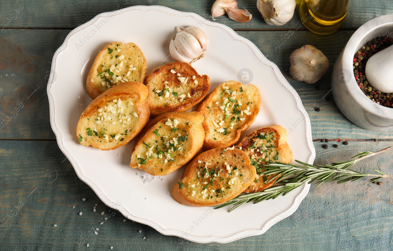 Photo of Flat lay composition with tasty homemade garlic bread on table