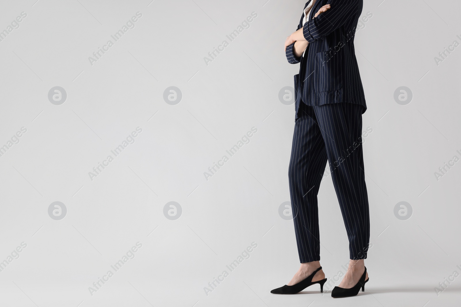 Photo of Businesswoman with crossed arms on white background, closeup