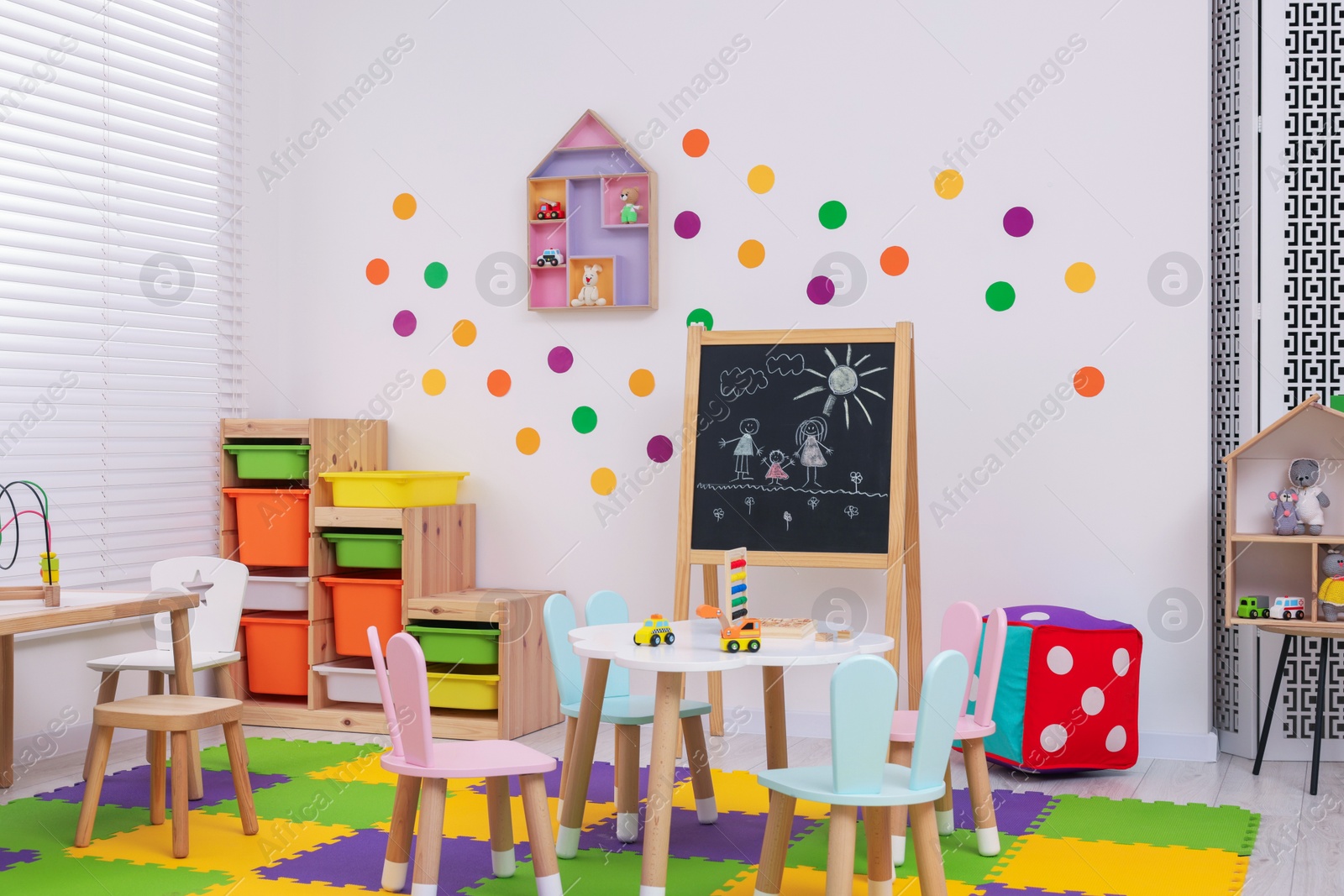 Photo of Stylish kindergarten interior with toys and modern furniture