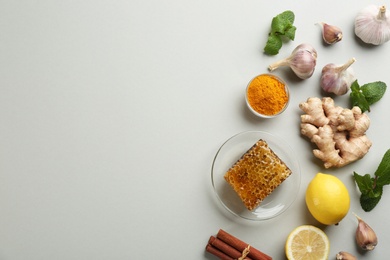 Photo of Flat lay composition with fresh products on grey background, space for text. Natural antibiotics