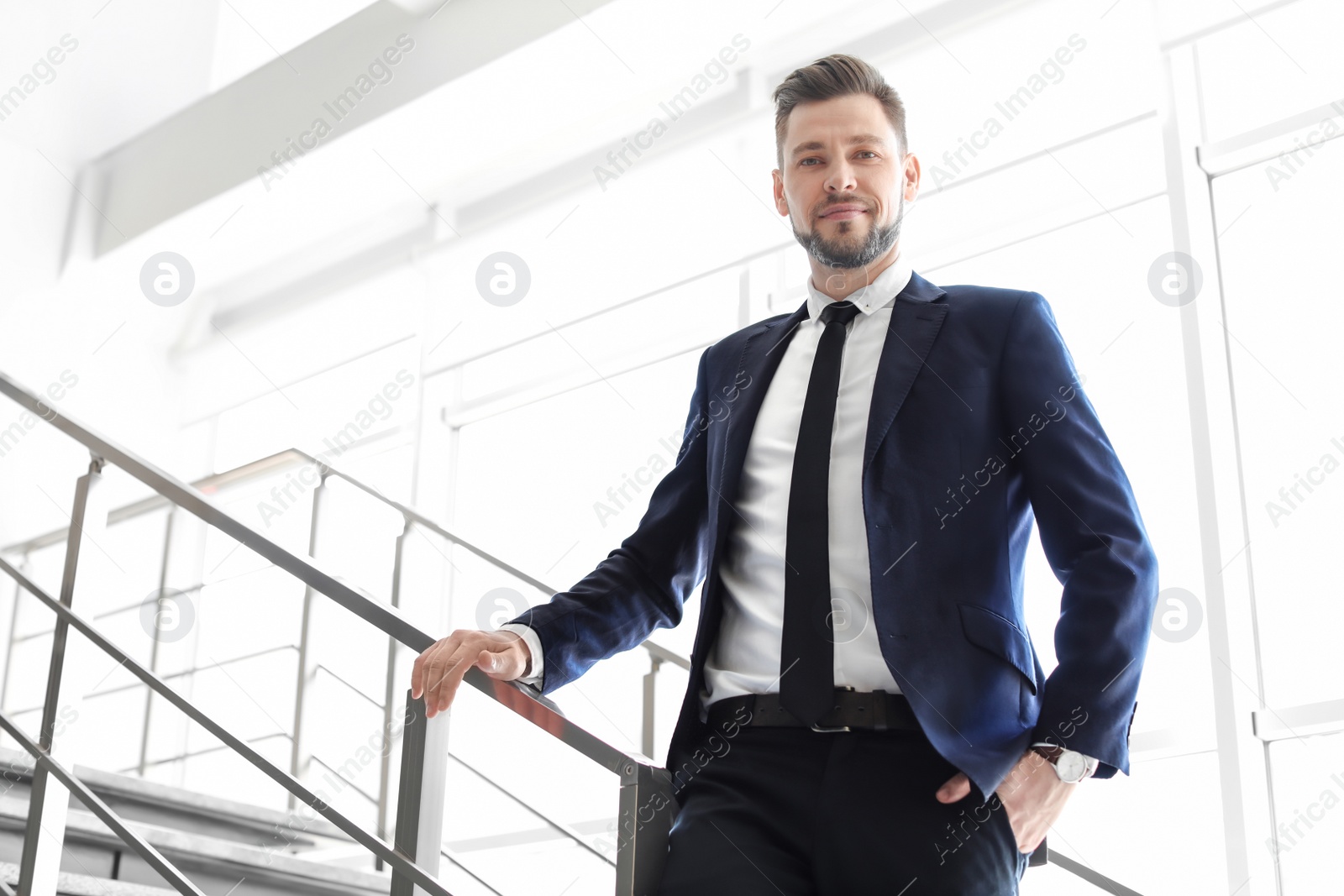 Photo of Male lawyer standing near stairs in office