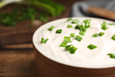 Photo of Fresh sour cream with onion in bowl, closeup