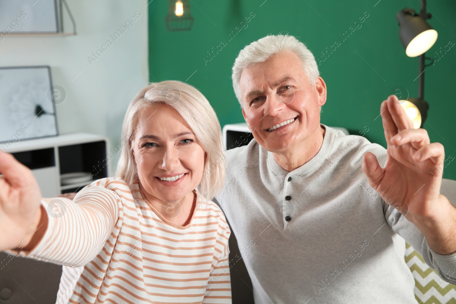 Photo of Mature couple using video chat at home, view from web camera