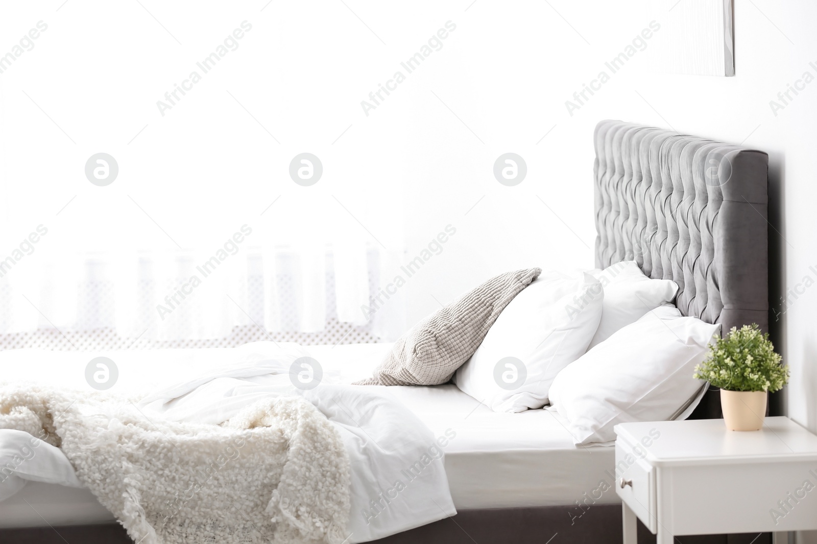 Photo of Stylish bedroom interior with comfortable bed