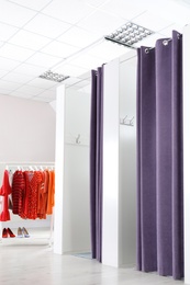 Photo of Fashion store interior with dressing rooms. Modern design