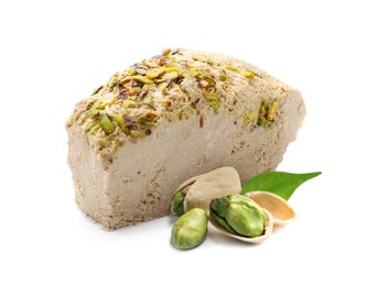 Image of Tasty halva, pistachio nuts and green leaf isolated on white