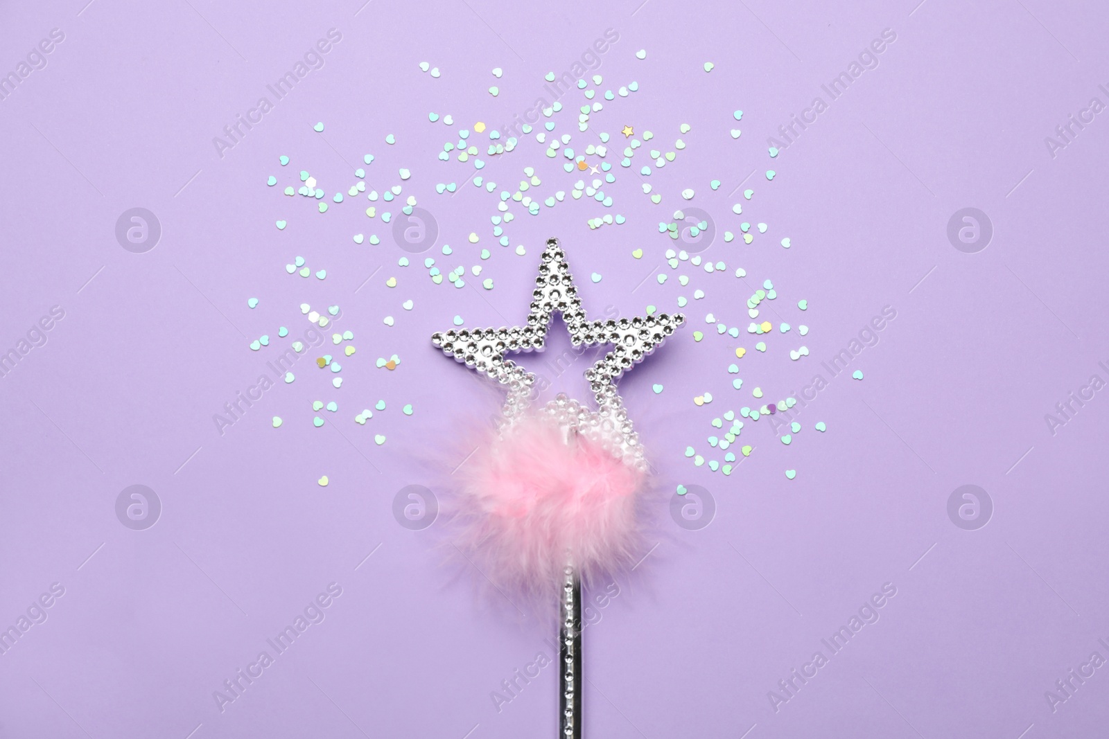 Photo of Beautiful silver magic wand with feather and confetti on lilac background, flat lay