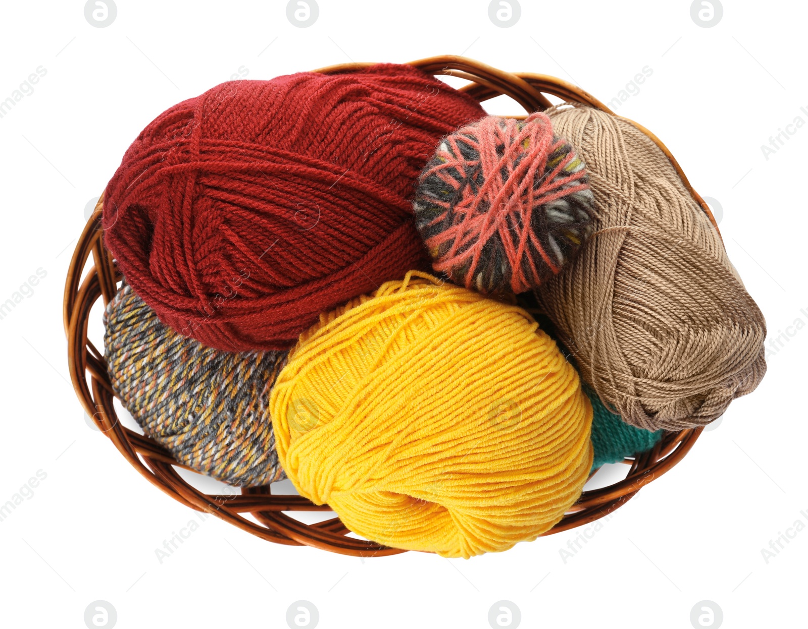 Photo of Different balls of woolen knitting yarns in wicker basket on white background, top view