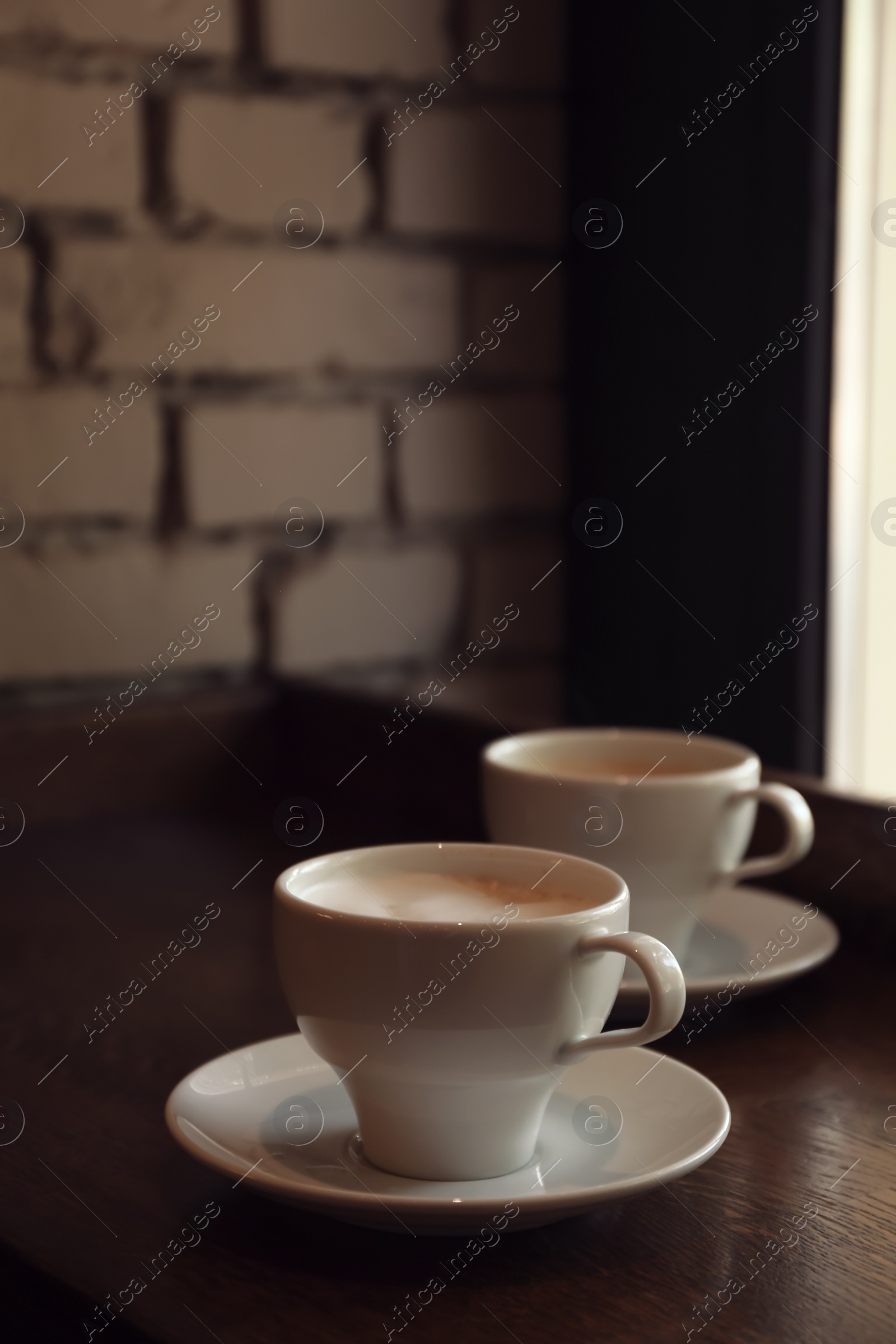 Photo of Cups of fresh aromatic coffee on table