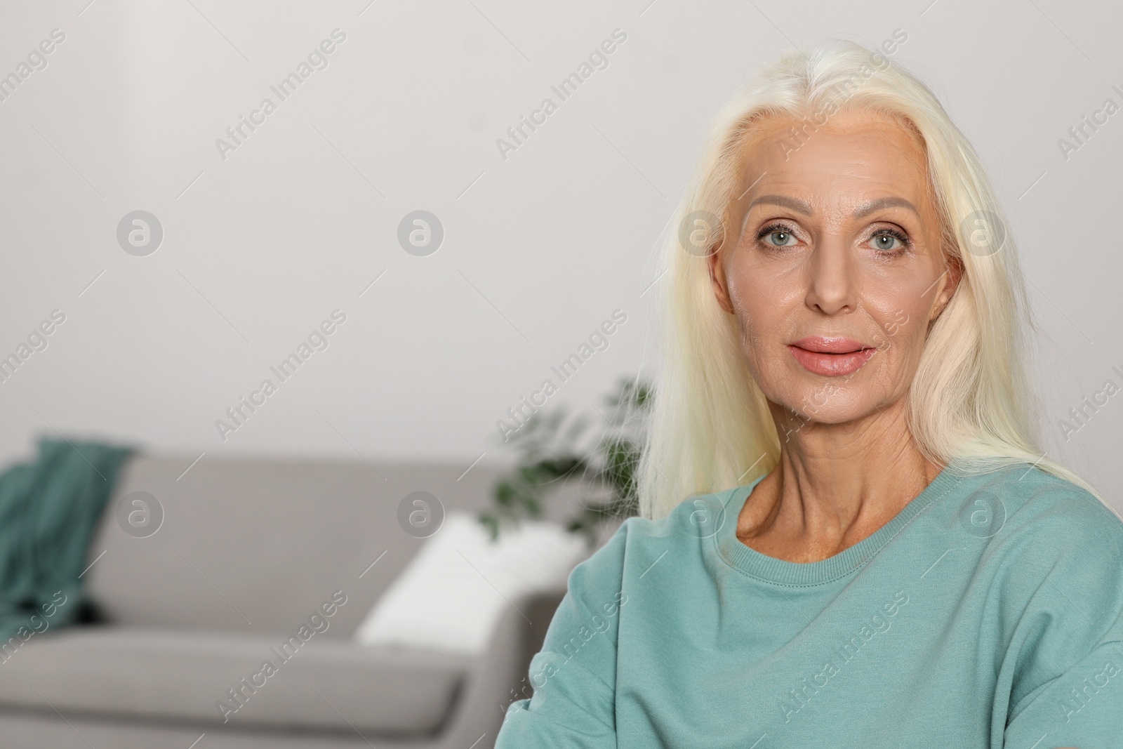 Photo of Portrait of elegant mature woman at home. Space for text