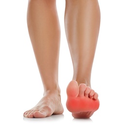 Woman suffering from foot pain on white background, closeup