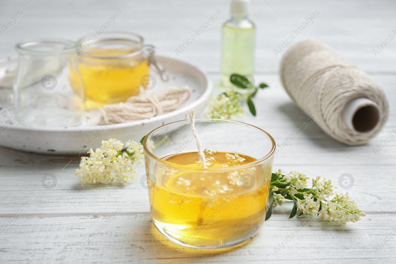 Photo of Process of making candle on wooden background