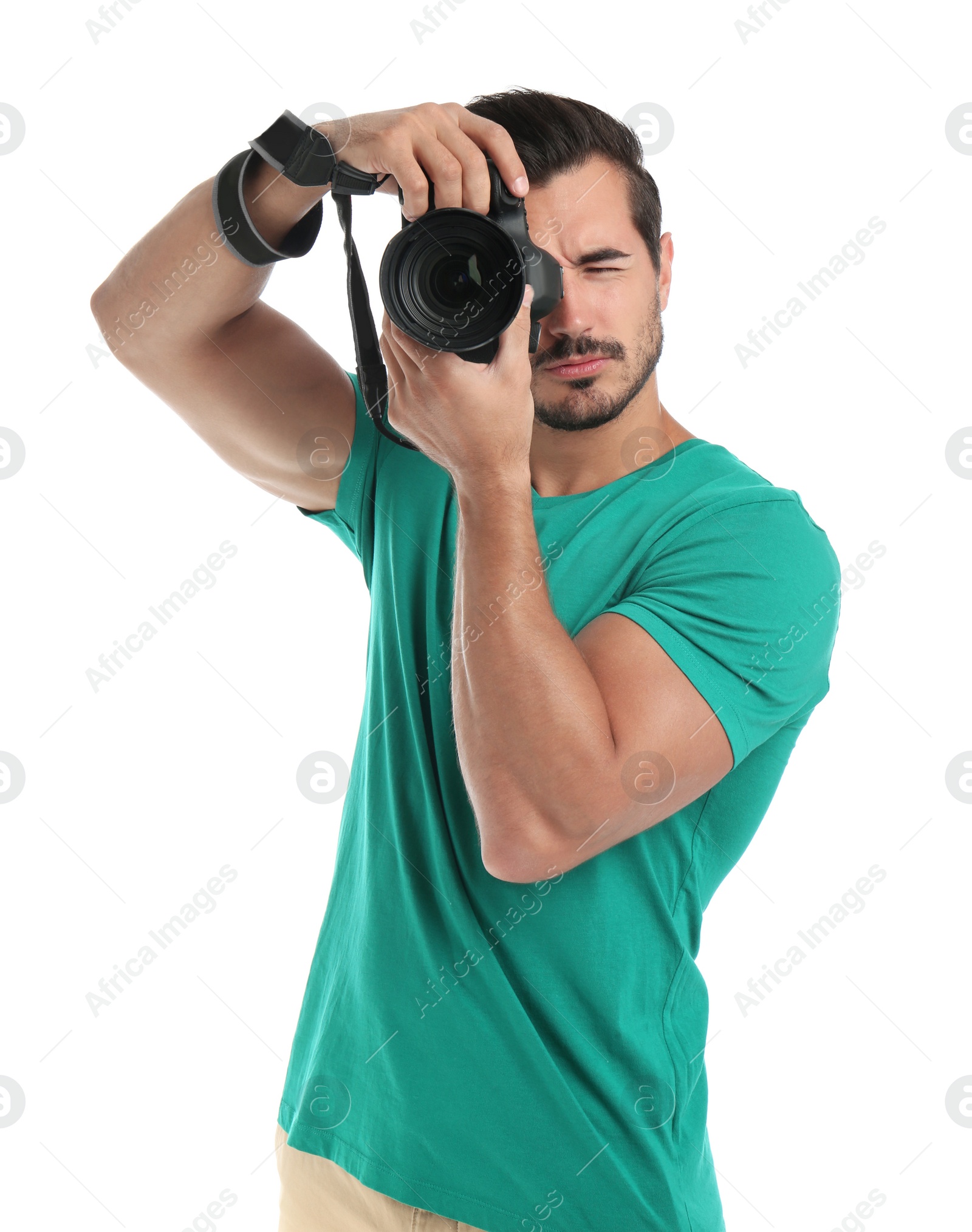 Photo of Young professional photographer taking picture on white background