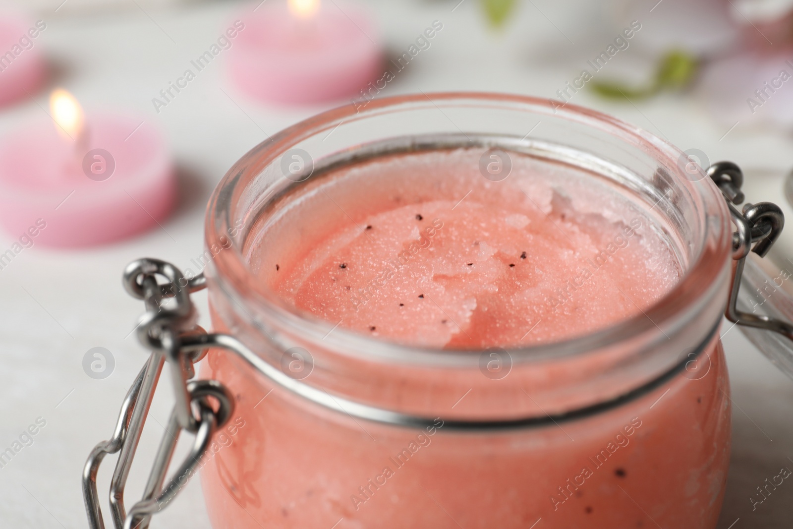 Photo of Glass jar with organic scrub on table, closeup