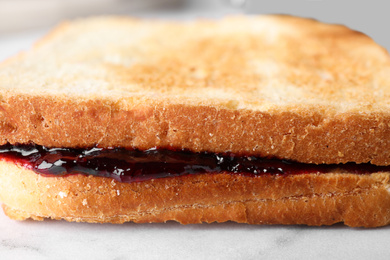 Tasty sandwich with raspberry jam for breakfast, closeup