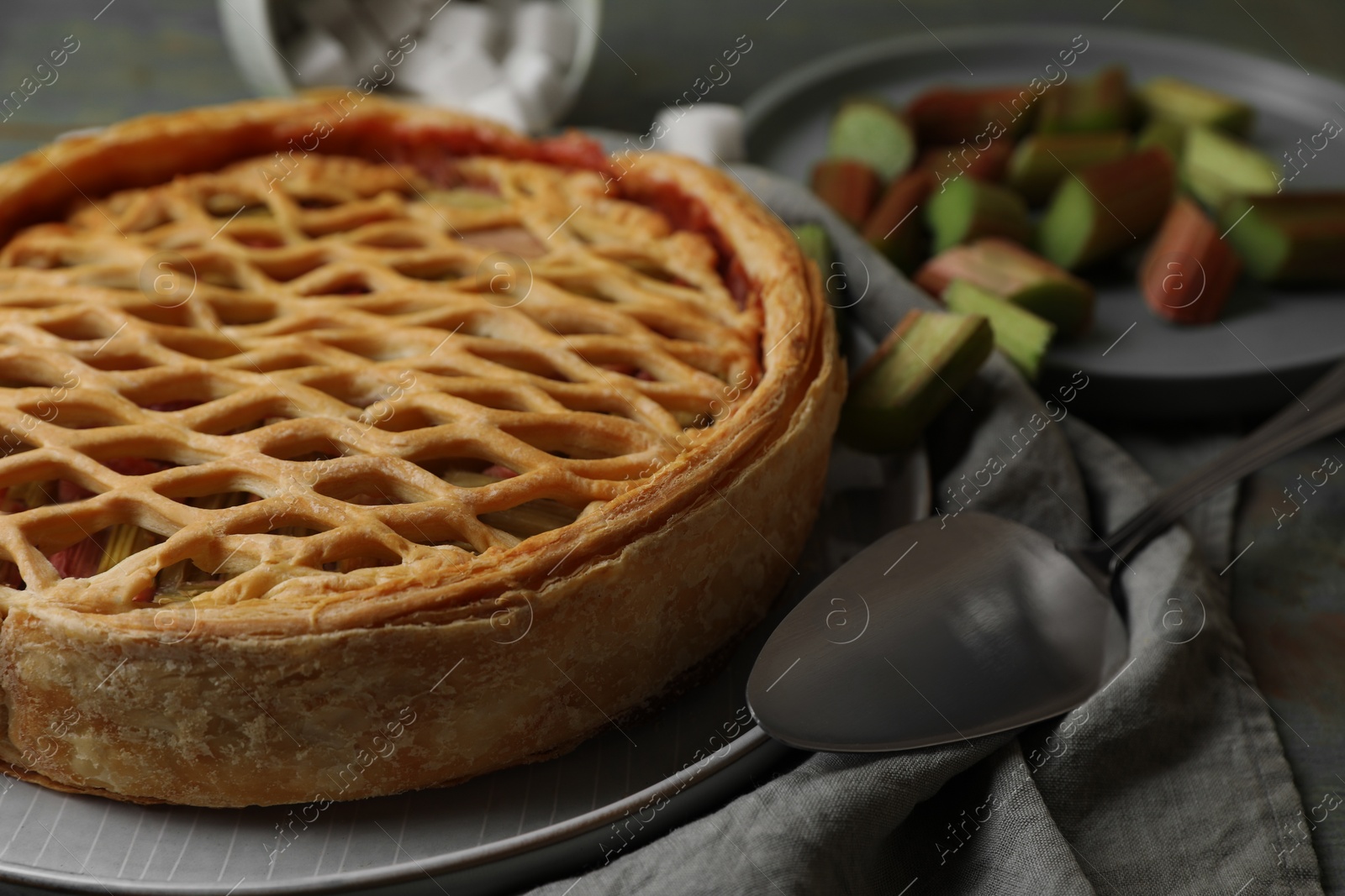 Photo of Freshly baked rhubarb pie and cake server on table, closeup