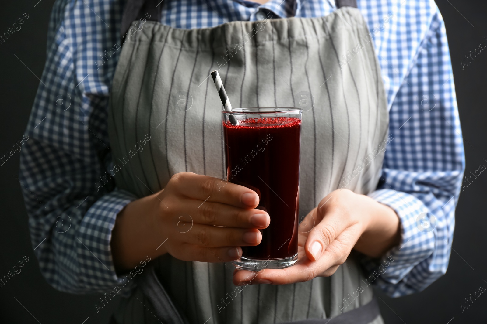 Photo of Woman with glass of fresh beet juice, closeup