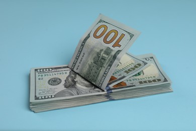 Money exchange. Dollar banknotes on light blue background