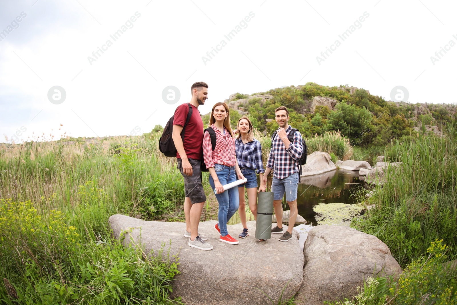 Photo of Group of young people in wilderness. Camping season