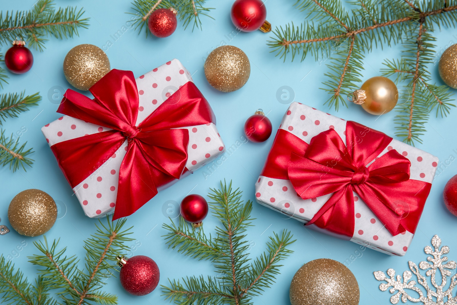 Photo of Flat lay composition with Christmas tree branches, festive decor and gift boxes on color background