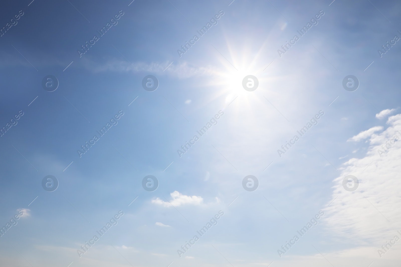 Photo of Sun and white clouds in blue sky outdoors