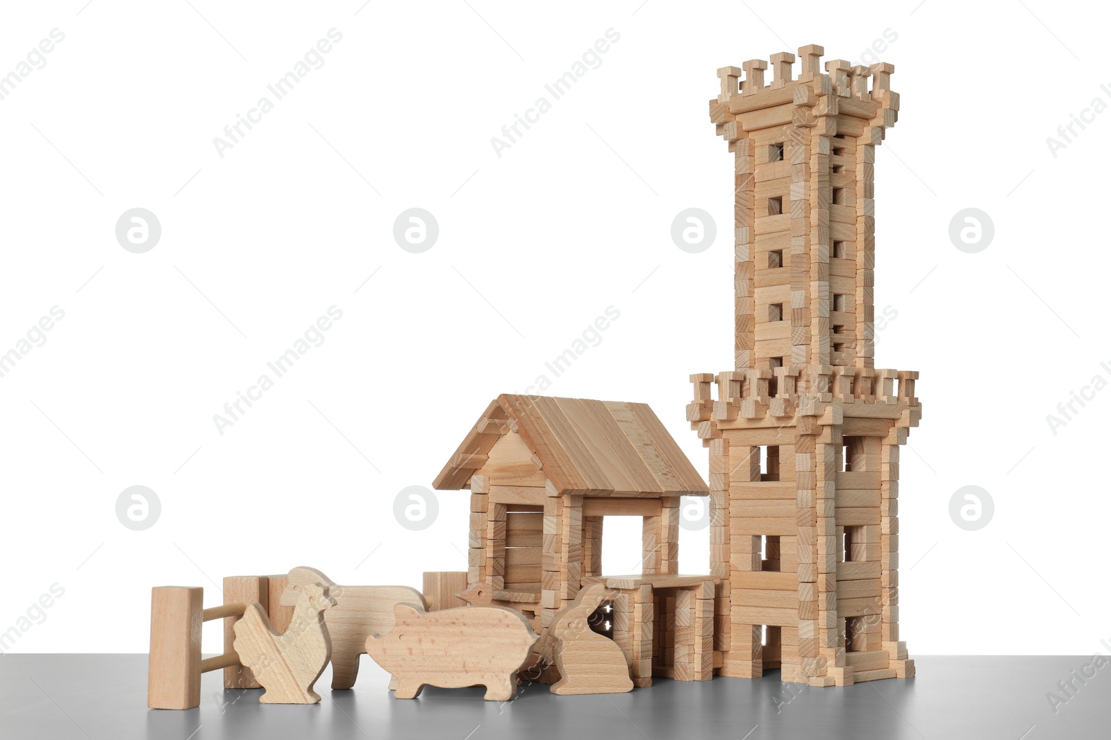 Photo of Set of wooden toys on light grey table against white background. Children's development