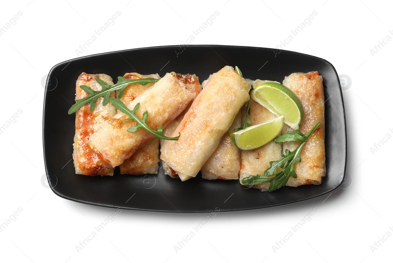 Photo of Tasty fried spring rolls, arugula and lime isolated on white, top view
