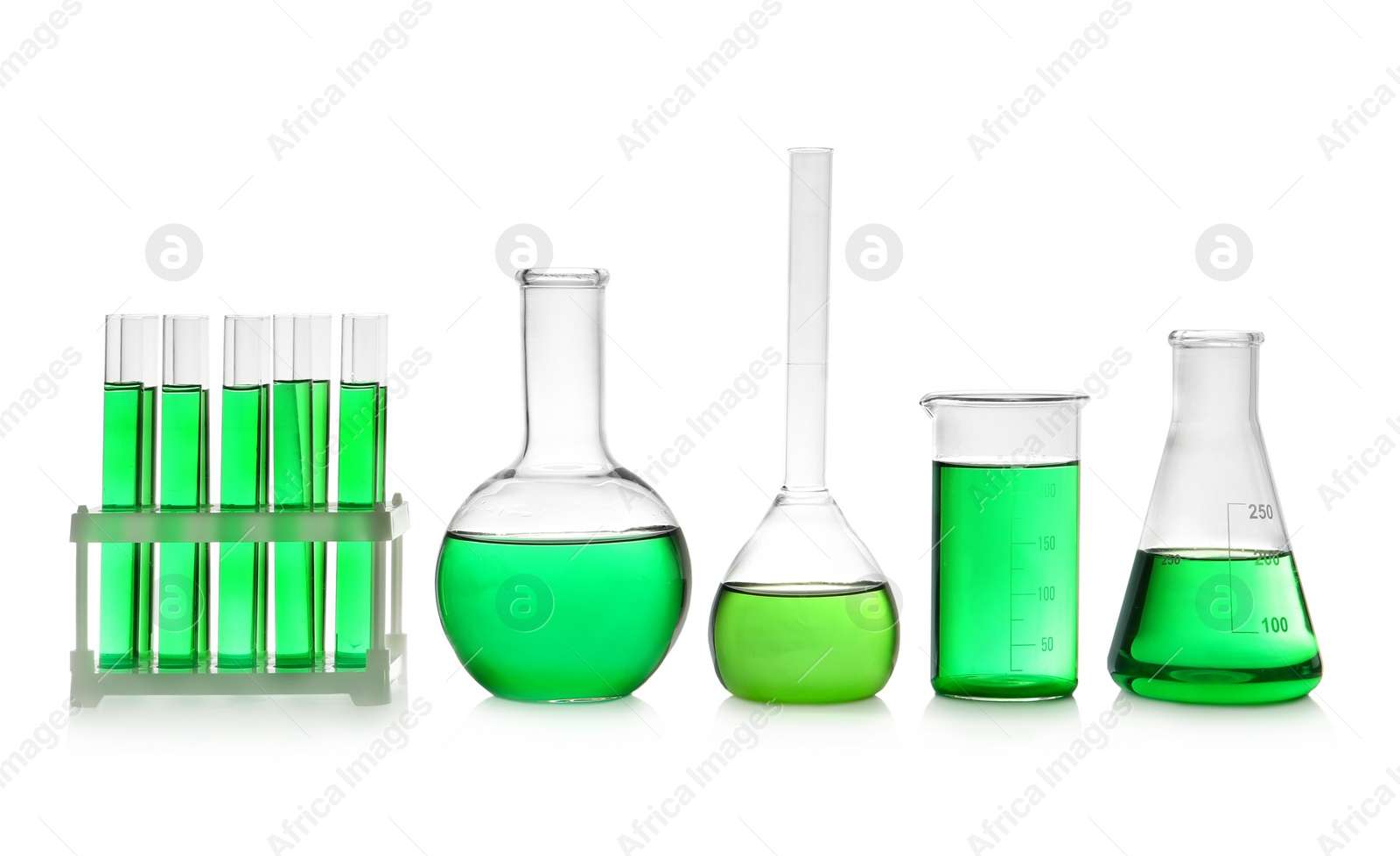 Photo of Laboratory glassware with green liquid on white background