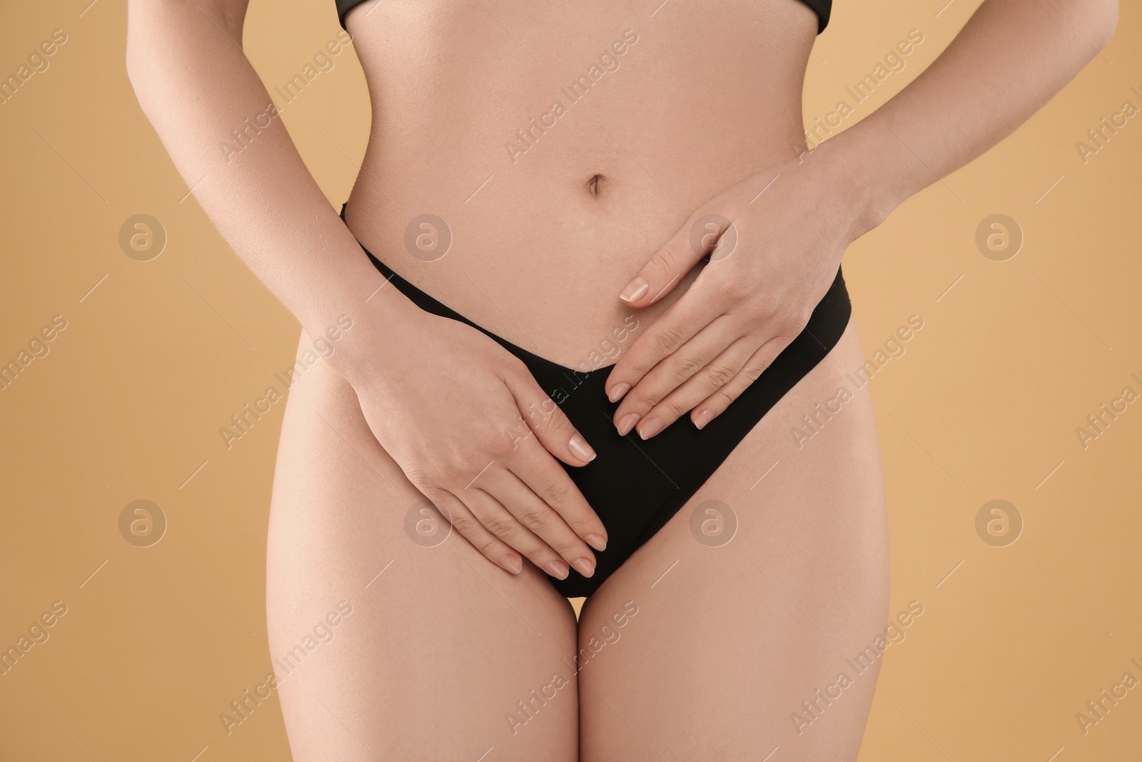 Photo of Gynecology. Woman in underwear on yellow background, closeup