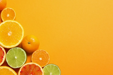 Different citrus fruits on color background, flat lay. Space for text