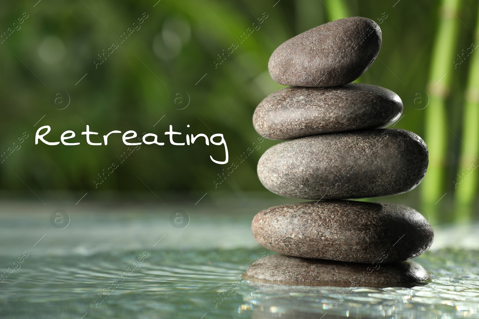 Image of Wellness retreat. Stacked pebble stones in water on blurred background, closeup