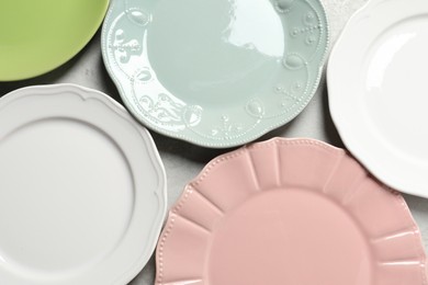 Beautiful ceramic plates on light grey table, flat lay